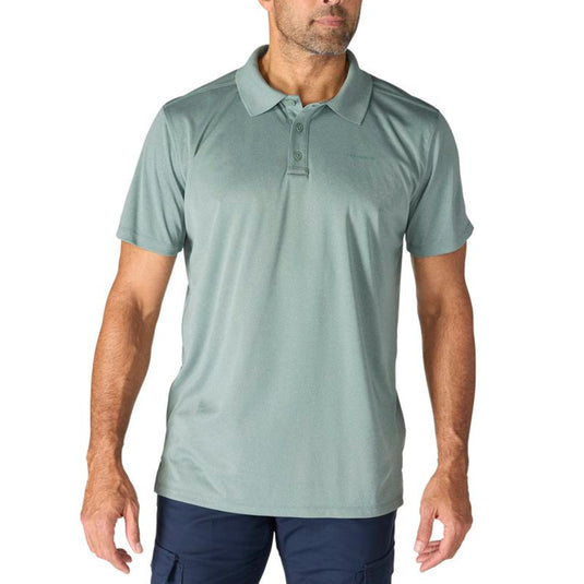 Man wearing a light green polo shirt on a white background