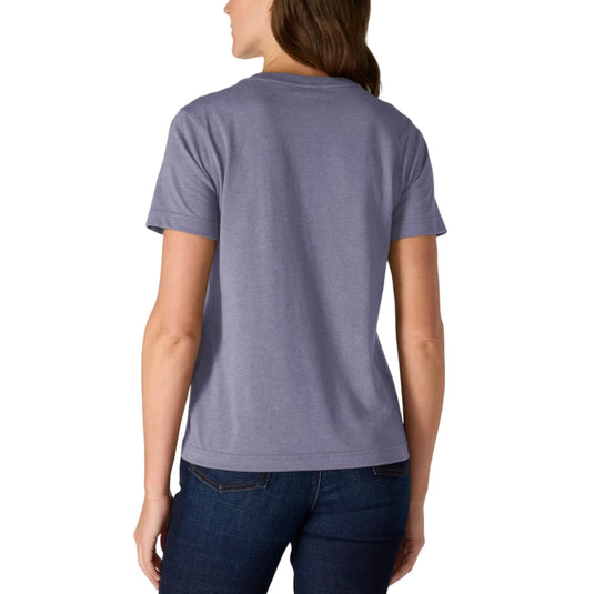 A woman viewed from the back wearing a heathered periwinkle blue short-sleeve t-shirt and dark blue jeans, set against a plain white background.