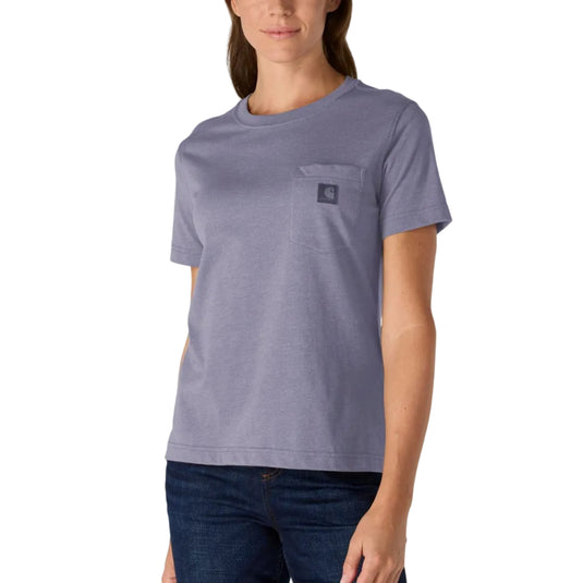 A woman modeling a short-sleeve crewneck pocket t-shirt in a heathered periwinkle purple color, paired with dark blue jeans, against a solid white background.