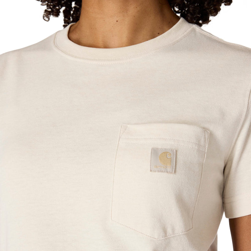 Load image into Gallery viewer, Close-up of a person wearing a light cream/off-white short-sleeve pocket T-shirt with a visible Carhartt chest patch logo.
