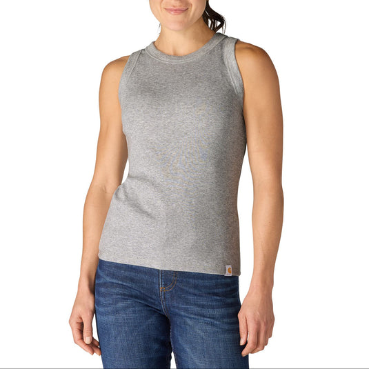 Woman wearing a gray sleeveless tank top and blue jeans on a white background