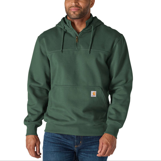 Man wearing a green hoodie with a visible brand logo on a white background