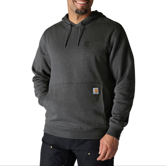 A man wearing a dark gray heathered Carhartt hoodie with a small signature logo patch on the pocket, photographed against a solid white background.