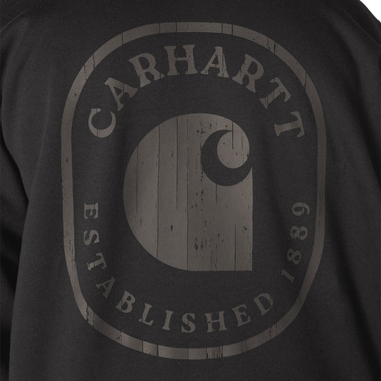Close-up of a dark charcoal gray sweatshirt featuring a distressed, faded gray Carhartt logo graphic on the front.