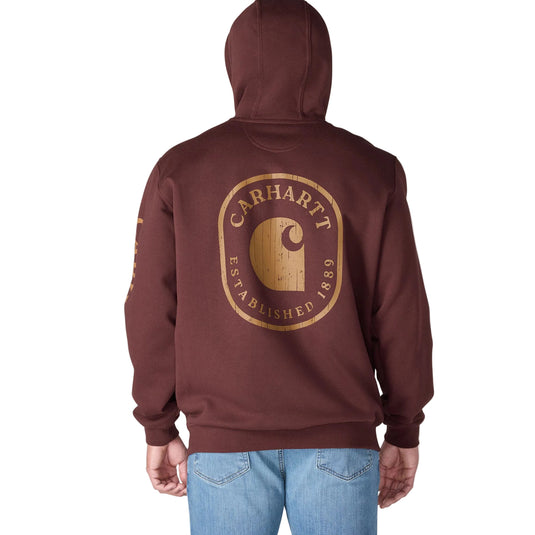 Back view of a person wearing a maroon Carhartt hoodie with a cracked 