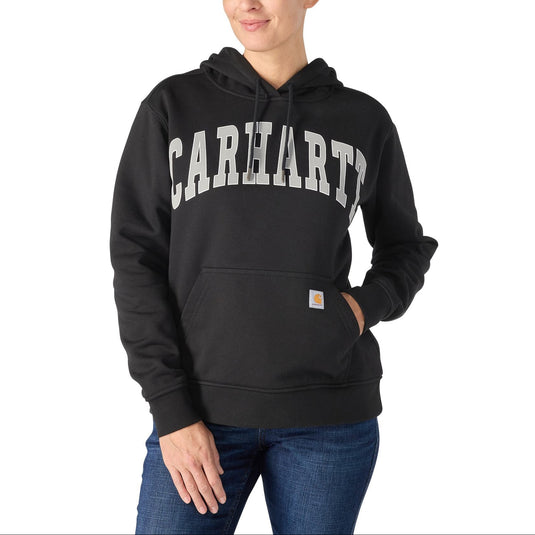 Woman wearing a black Carhartt swater hoodie with "Carhartt" in bold lettering on the front.