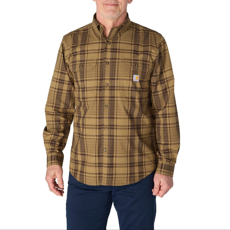 Load image into Gallery viewer, A man wearing a brown and tan plaid button-down shirt with a small Carhartt logo patch on the chest pocket, paired with dark blue pants, against a plain white background.
