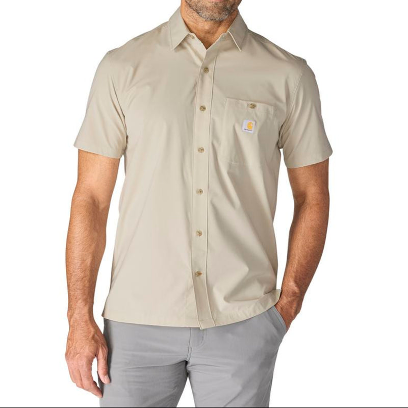 Load image into Gallery viewer, Man wearing a beige (Cobblestone)  short-sleeve button-up shirt with a Carhartt logo on the left chest pocket on a white background
