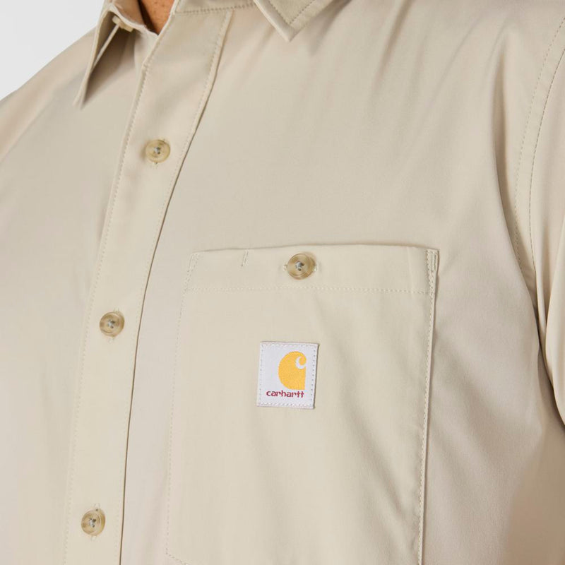 Load image into Gallery viewer, Beige short-sleeve button-up shirt with Carhartt logo and button on the left chest pocket on a white background
