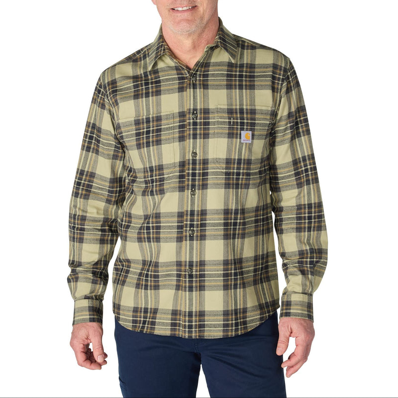 Load image into Gallery viewer, A man wearing a Carhartt long-sleeve plaid button-down shirt in olive green and beige with dark brown and black lines, paired with navy pants, against a plain white background.
