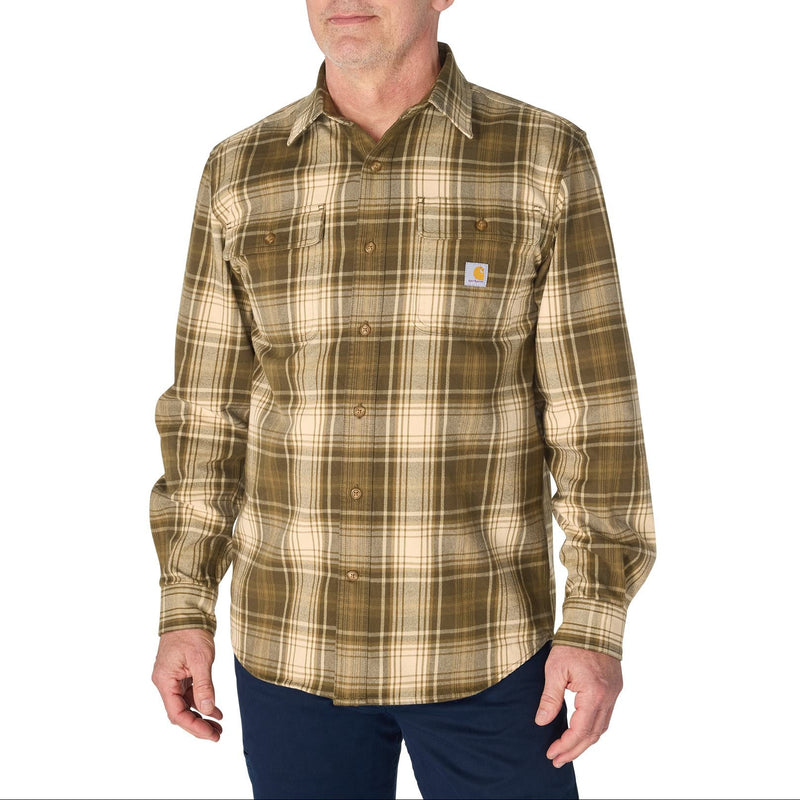 Load image into Gallery viewer, A man wearing a Carhartt long-sleeve plaid button-up shirt in olive green and tan, paired with dark blue pants, against a plain white background.
