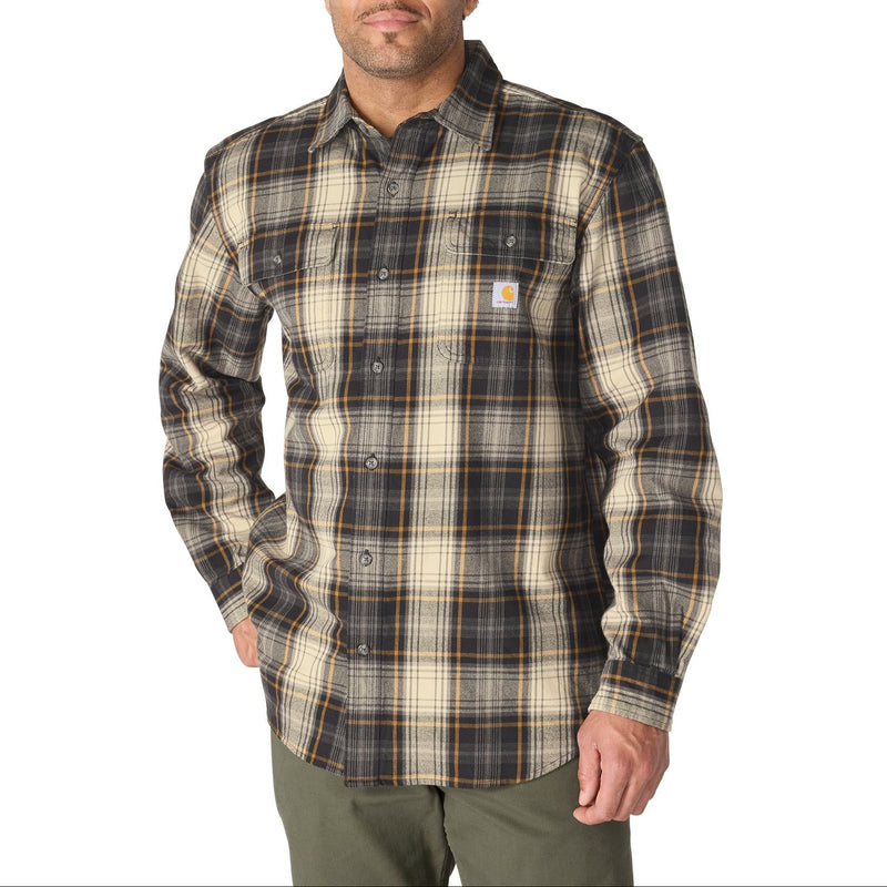Load image into Gallery viewer, A man wearing a long-sleeve plaid button-up shirt by Carhartt, featuring a dark brown, beige, and black pattern, against a plain white background.
