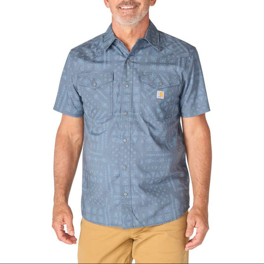 Man wearing a blue patterned shirt with Carhartt logo on a white background