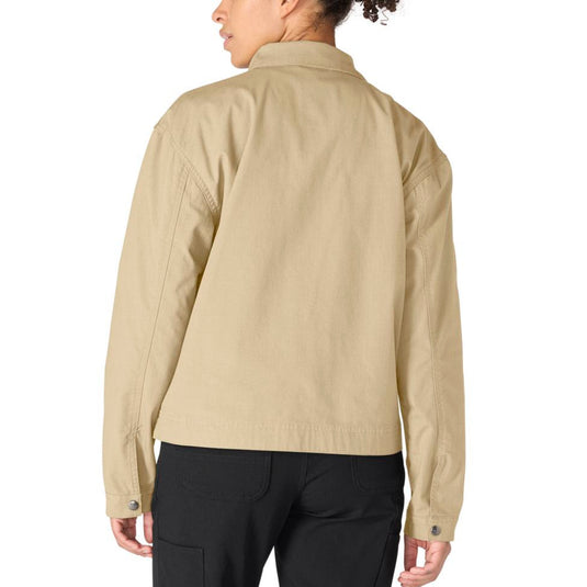 Person wearing a beige Carhartt jacket on a white background