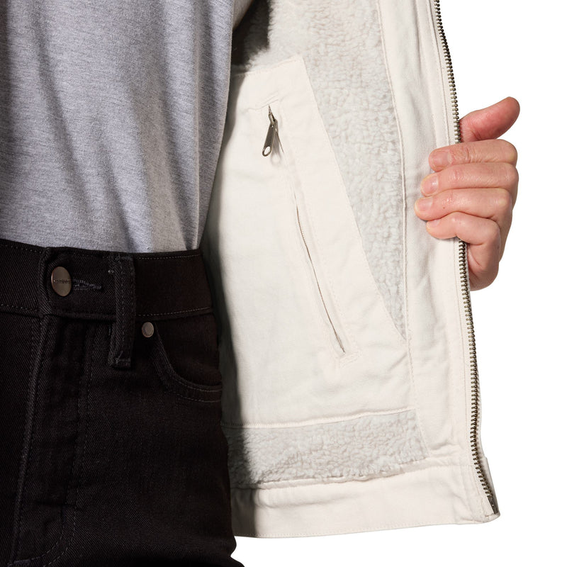 Load image into Gallery viewer, Close-up of a person wearing a light cream zip-front jacket with a soft fleece lining, paired with a gray T-shirt and black jeans against a white background.
