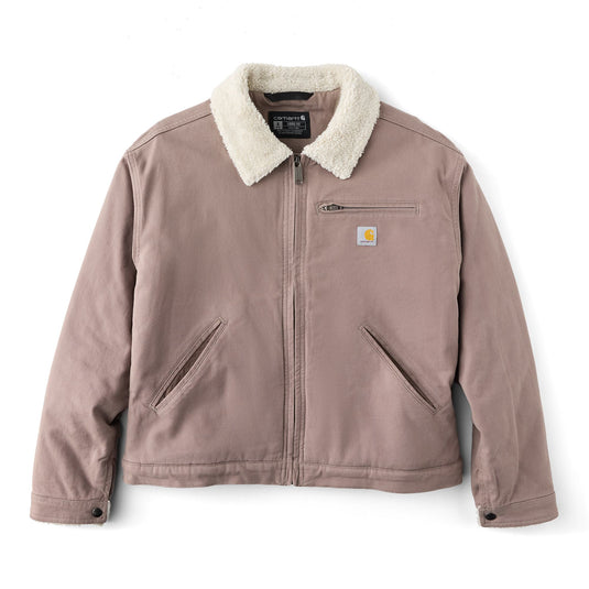 A Carhartt jacket in dusty rose canvas with a cream sherpa collar, featuring a front zipper, zippered chest pocket, and two diagonal welt pockets.