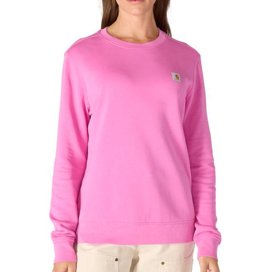 Person wearing a pink sweatshirt with a Carhartt logo on a white background