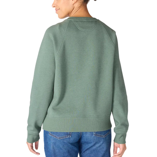 A woman shown from the back wearing a sage green crewneck sweatshirt and blue jeans against a plain white background.