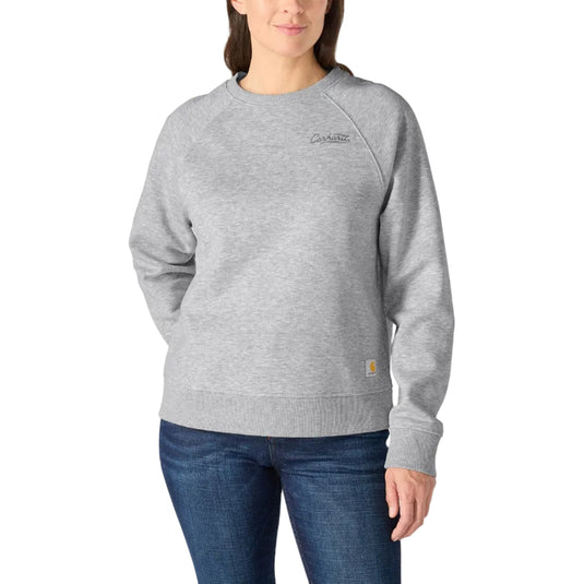 Woman wearing a gray sweatshirt with a Carhartt logo on a white background