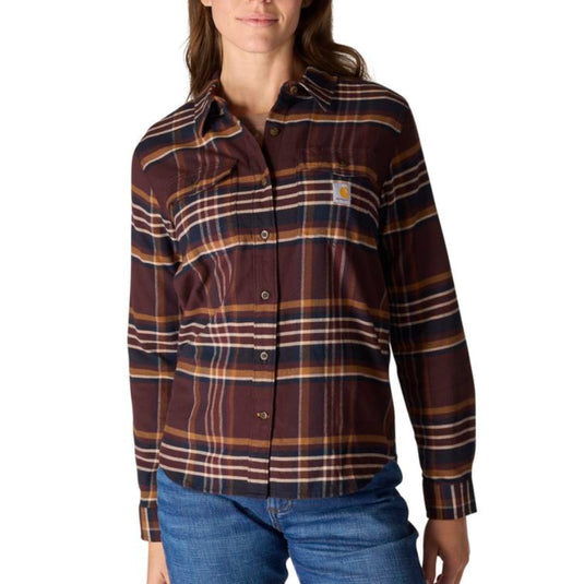 Woman wearing a plaid shirt with a visible brand logo on a white background