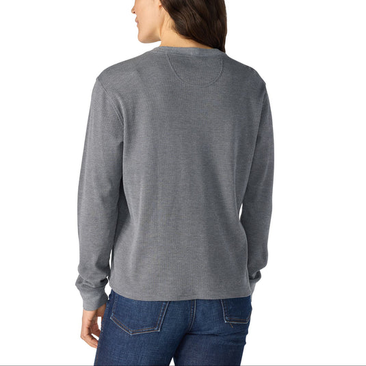 A woman shown from the back wearing a heather gray long-sleeve shirt and blue jeans against a plain white background.
