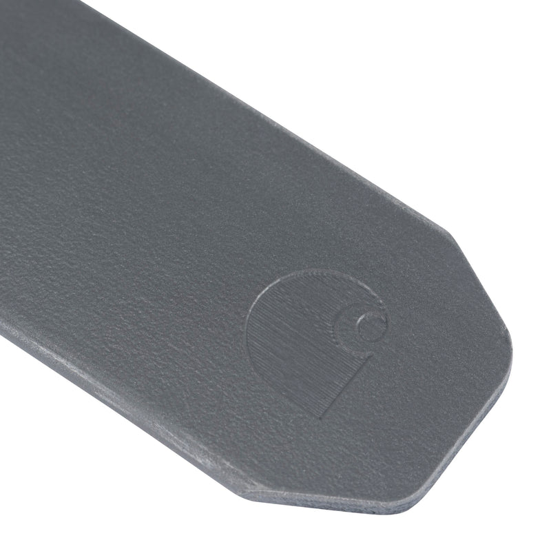 Load image into Gallery viewer, Close-up of a dark gray belt tip with a debossed Carhartt logo on a white background.
