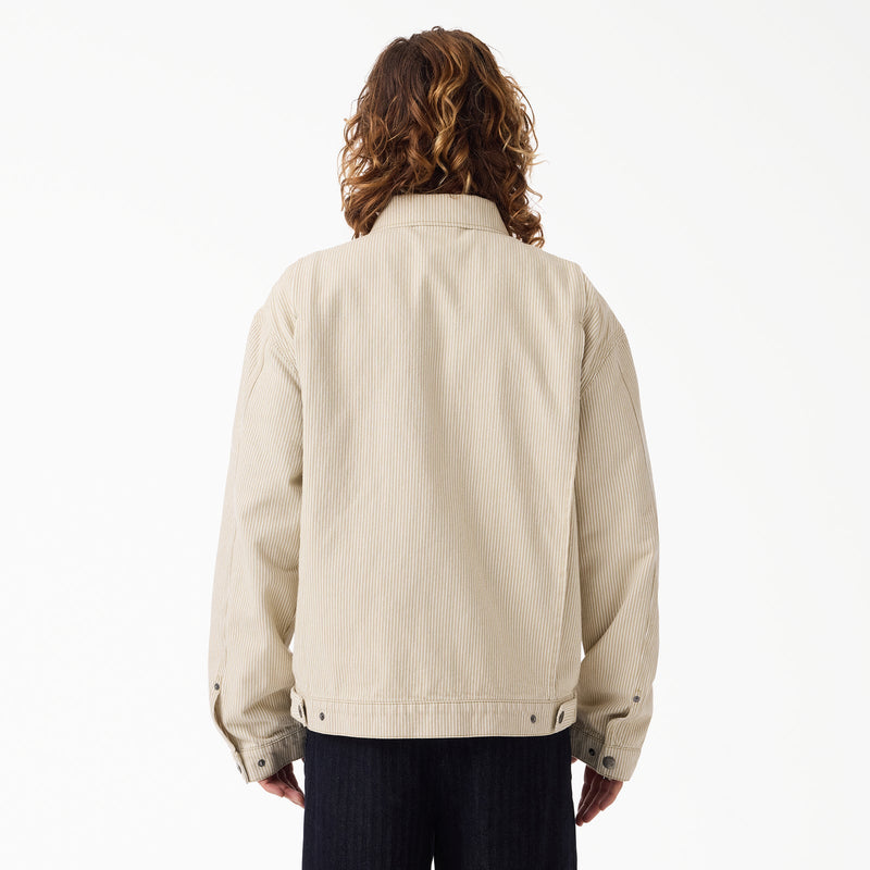 Load image into Gallery viewer, The back of a model wearing a timeless retro sand color hickory stripe painter's jacket.
