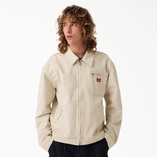 The front of a model wearing a timeless retro light brown hickory stripe painter's jacket.