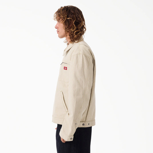 The side of a model wearing a timeless retro beige hickory stripe painter's jacket.