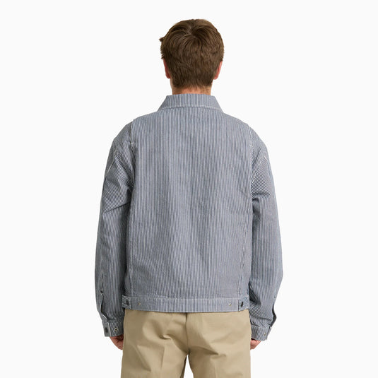 The back of a model wearing a timeless retro indigo blue hickory stripe painter's jacket.