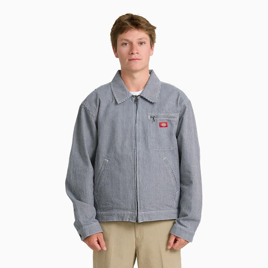 A model wearing a timeless retro indigo blue hickory stripe painter's jacket.