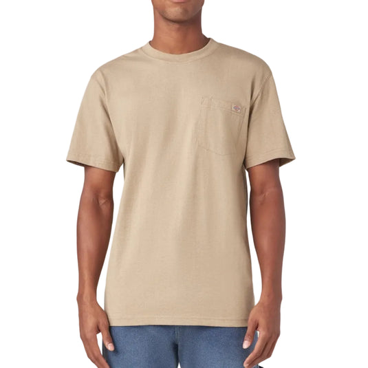 Man wearing a beige t-shirt and blue jeans on a white background