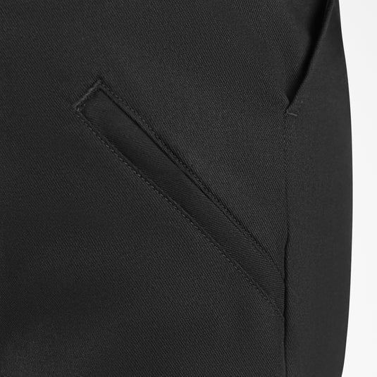 Close-up of a black shorts with a pocket detail on a white background
