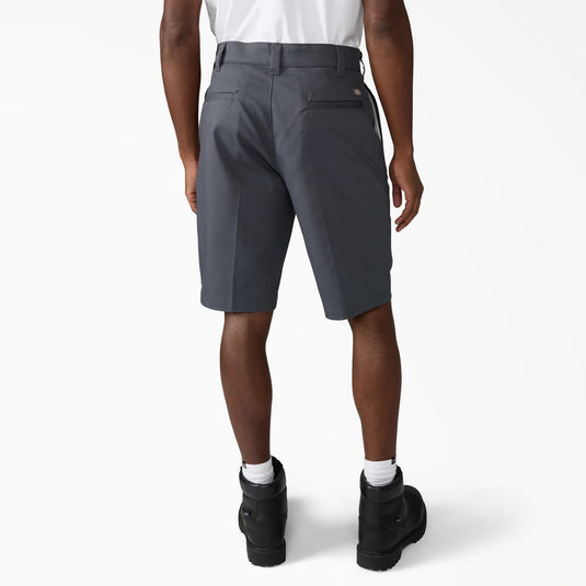 Person wearing gray shorts on a white background