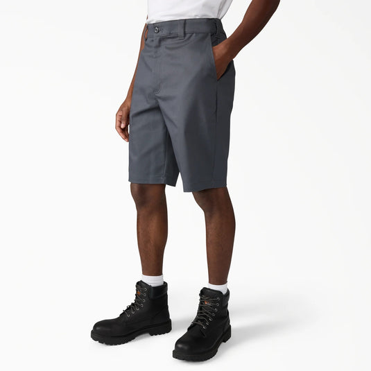 Person wearing gray shorts and black boots on a white background