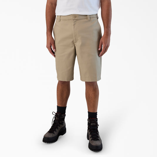 Person wearing beige shorts on a white background