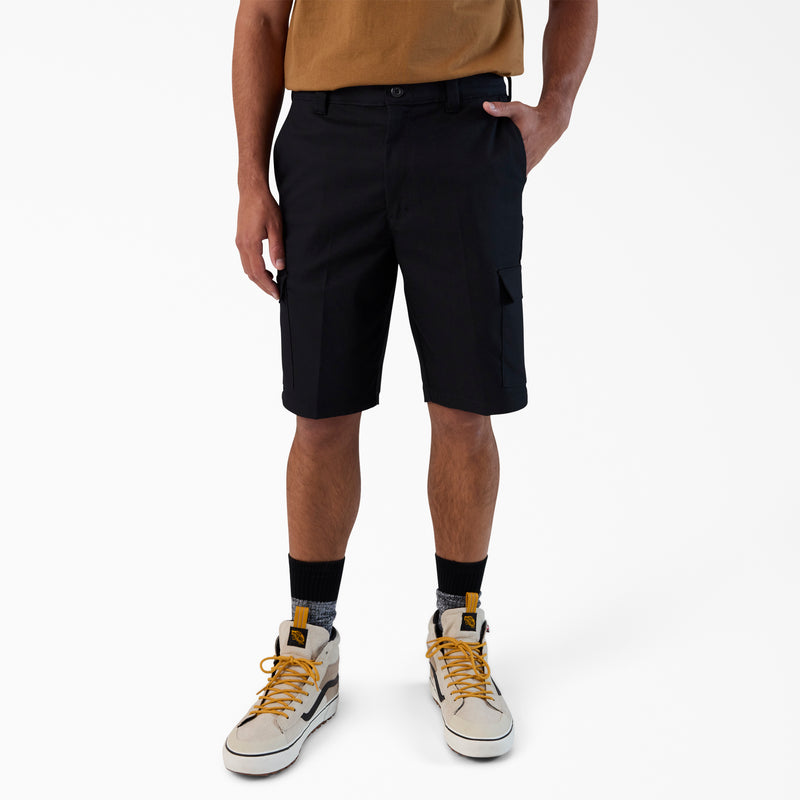 Load image into Gallery viewer, Person wearing black shorts, a tan shirt, and white sneakers with yellow laces on a white background
