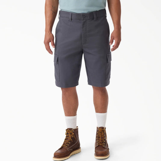 Person wearing gray cargo shorts with a white background