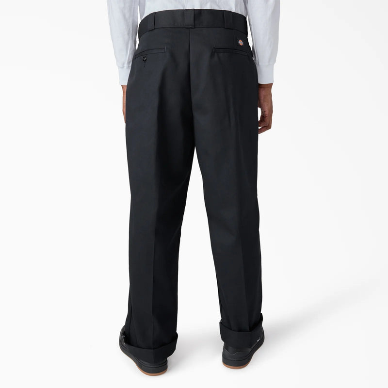 Load image into Gallery viewer, Black loose fit workpants worn by a person on a white background
