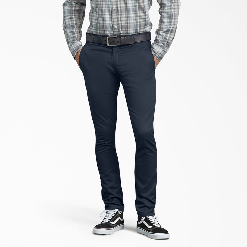 Load image into Gallery viewer, Person wearing navy pants with a plaid shirt and black and white sneakers on a white background
