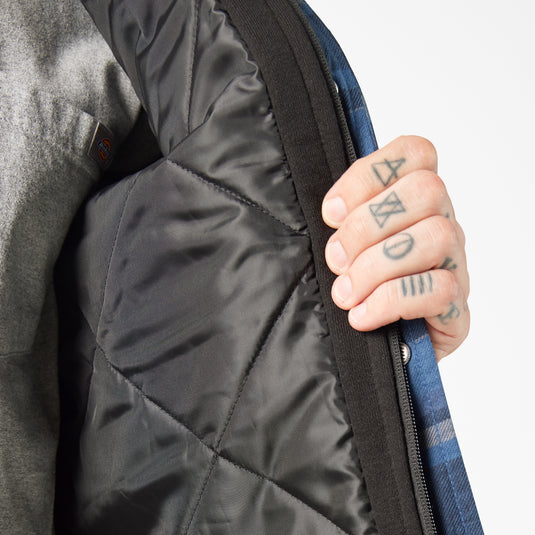 Person showing the black quilted interior of the jacket with a close-up of the fabric texture.