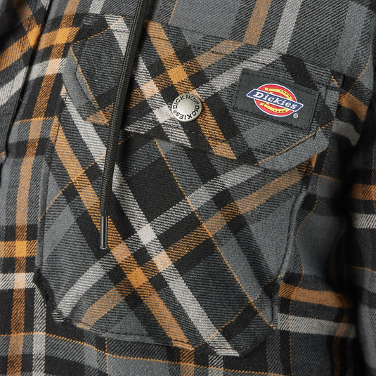 Plaid jacket with Dickies logo on a close-up of a pocket