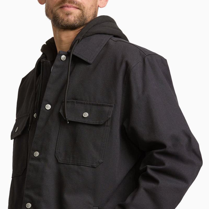 Load image into Gallery viewer, A close-up of a man wearing a black hooded overshirt jacket with a snap-button front, chest flap pocket, and drawstring hood, photographed against a plain white background.
