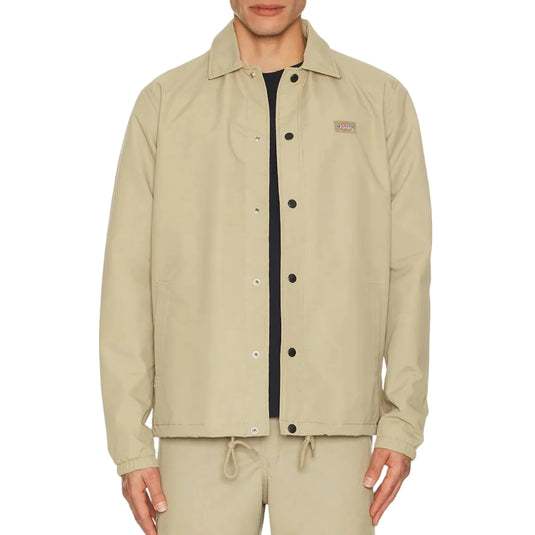 Person wearing a Khaki coaches jacket set on a white background