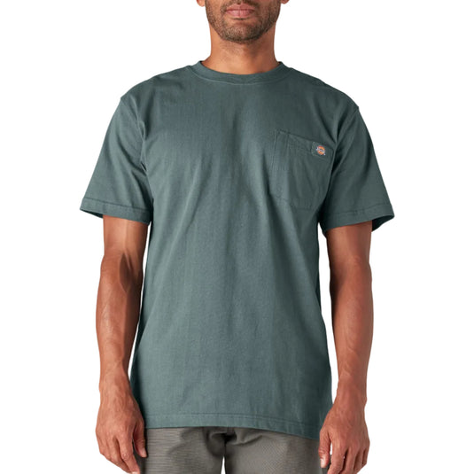 Man wearing a green t-shirt with a pocket on a white background