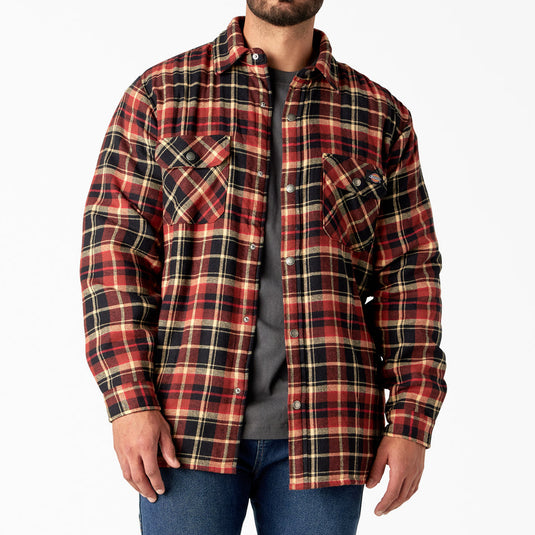 Man wearing a red and black sherpa lined plaid shirt jacket on a white background