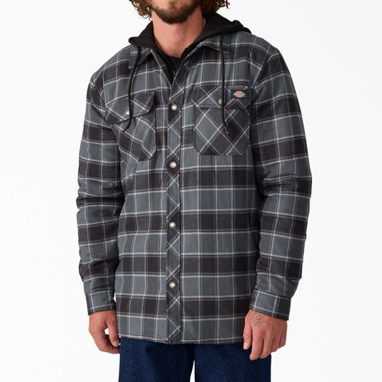 Man wearing a gray and black plaid shirt jacket with a hood on a white background