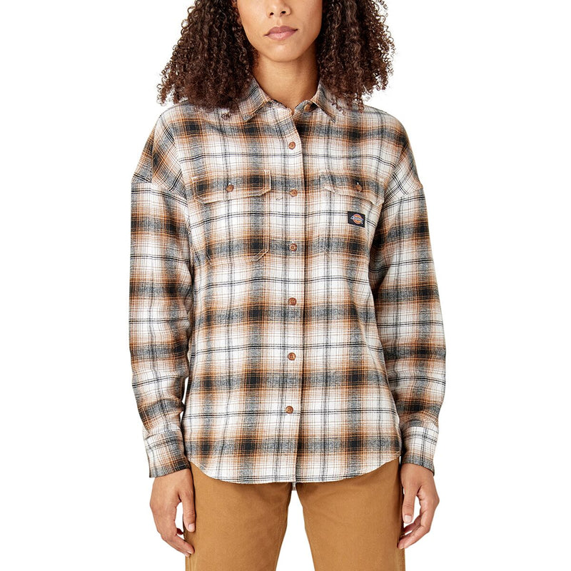 Load image into Gallery viewer, A woman wearing a long-sleeve plaid button-up shirt in brown, beige, and black tones, paired with tan pants, against a plain white background.
