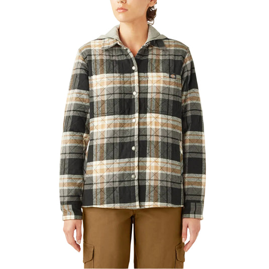 Person wearing a plaid shirt and brown pants on a white background