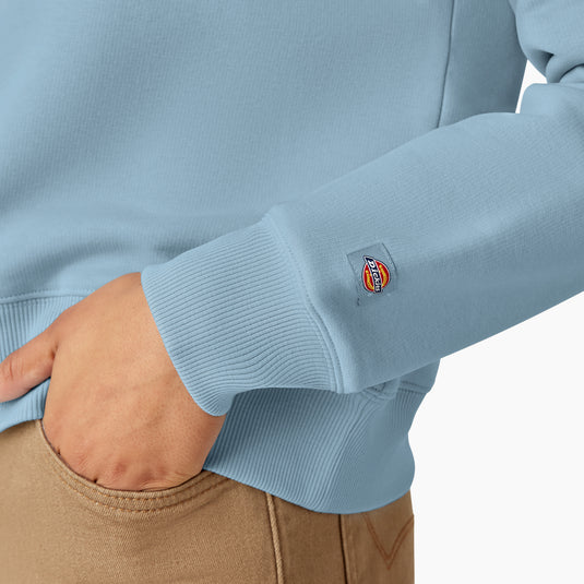 This light blue heavyweight fleece crewneck sweatshirt features a relaxed fit, shorter length that falls just below the waist,  has a woven Dickies logo on the left sleeve.